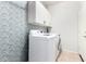 Laundry room with cabinetry, washer, dryer and decorative accent wall at 9142 W Pontiac Dr, Peoria, AZ 85382