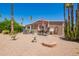 Backyard features a patio set, bird bath, desert landscape, and palm trees at 9302 E Broadway Rd # 122, Mesa, AZ 85208