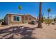 Backyard features palm trees, decorative flower pots, desert landscape, and gravel at 9302 E Broadway Rd # 122, Mesa, AZ 85208