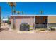 Backyard patio with a grill, palm trees and a Corona Extra themed ice chest at 9302 E Broadway Rd # 122, Mesa, AZ 85208