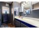 Bathroom featuring navy cabinets and a white countertop at 9302 E Broadway Rd # 122, Mesa, AZ 85208