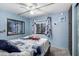 Bright bedroom with blue walls, white trim, and a decorative wreath above the bed at 9302 E Broadway Rd # 122, Mesa, AZ 85208