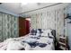 Comfortable bedroom with blue and white bedding and a decorative wood accent wall at 9302 E Broadway Rd # 122, Mesa, AZ 85208