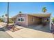 Charming home featuring covered parking and a well-maintained desert-style landscaped front yard at 9302 E Broadway Rd # 122, Mesa, AZ 85208