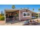 Charming home featuring covered parking and a well-maintained desert-style landscaped front yard at 9302 E Broadway Rd # 122, Mesa, AZ 85208