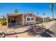 Charming home featuring covered parking and a well-maintained desert-style landscaped front yard at 9302 E Broadway Rd # 122, Mesa, AZ 85208