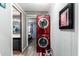 Hallway with in-unit laundry next to the bathroom and bedroom entrances at 9302 E Broadway Rd # 122, Mesa, AZ 85208