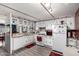 Functional kitchen with white appliances and vintage style cabinets at 9302 E Broadway Rd # 122, Mesa, AZ 85208