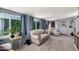 Bright living room with large windows, plush sofas and chairs, and cozy decor at 9302 E Broadway Rd # 122, Mesa, AZ 85208