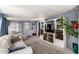 Cozy living room featuring plush carpet, entertainment center, and neutral color palette at 9302 E Broadway Rd # 122, Mesa, AZ 85208