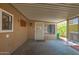 Covered patio area featuring a security door and ample space for seating or outdoor storage at 9302 E Broadway Rd # 122, Mesa, AZ 85208