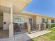 The home features a porch with a brick pillar and an iron railing and furniture at 9915 W Mountain View Rd, Sun City, AZ 85351