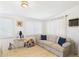 The living room features an end table with a lamp, a window, and a couch with blue pillows at 9915 W Mountain View Rd, Sun City, AZ 85351