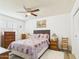 Comfortable main bedroom showcasing wood-look floors, neutral paint, and a ceiling fan at 9915 W Mountain View Rd, Sun City, AZ 85351