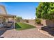 Well-maintained backyard featuring artificial turf, gravel, and a covered patio ideal for outdoor entertaining at 1030 S Brentwood Ct, Chandler, AZ 85286