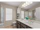 Bright bathroom with dual sinks, a linen cabinet, and a walk-in shower at 1030 S Brentwood Ct, Chandler, AZ 85286