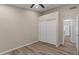 Bright bedroom with wood floors and a closet with sliding doors next to a door to another room at 1030 S Brentwood Ct, Chandler, AZ 85286