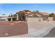 Charming single-story home showcasing a three-car garage, desert landscaping, and a Spanish tile roof at 1030 S Brentwood Ct, Chandler, AZ 85286