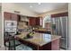 Well-appointed kitchen featuring granite countertops, stainless steel appliances, and a functional island with seating at 1030 S Brentwood Ct, Chandler, AZ 85286