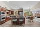 Modern kitchen with stainless steel appliances, granite counters, and an island with seating, next to dining area at 1030 S Brentwood Ct, Chandler, AZ 85286