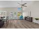 Open living area with wood floors, fireplace, ceiling fan, and doors leading to the backyard at 1030 S Brentwood Ct, Chandler, AZ 85286