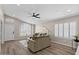 Cozy living room with wood-look flooring, large windows with shutters, and neutral decor at 1030 S Brentwood Ct, Chandler, AZ 85286