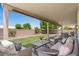 Relaxing covered patio with comfortable seating and a view of the neatly landscaped backyard at 1030 S Brentwood Ct, Chandler, AZ 85286