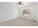 Serene bedroom with neutral carpet, bright window, and ample space for relaxation and rest, and ceiling fan at 1086 E Canyon Trail --, San Tan Valley, AZ 85143