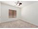 Carpeted bedroom featuring a ceiling fan and a window with blinds at 1086 E Canyon Trail --, San Tan Valley, AZ 85143
