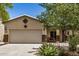 Charming single-story home with a two-car garage and desert landscaping in front yard at 1086 E Canyon Trail --, San Tan Valley, AZ 85143