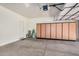 Spacious garage includes plenty of storage cabinets with a garage door and white walls at 1086 E Canyon Trail --, San Tan Valley, AZ 85143