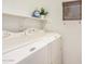 Efficient laundry area featuring stacked washer/dryer unit, practical shelving, and natural light, maximizing space at 1086 E Canyon Trail --, San Tan Valley, AZ 85143