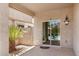 Covered patio area with sliding glass doors, outdoor seating, and desert landscaping at 1086 E Canyon Trail --, San Tan Valley, AZ 85143