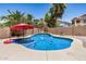 Backyard pool with custom rock waterfall feature, surrounded by lush tropical landscaping at 1086 E Canyon Trail --, San Tan Valley, AZ 85143