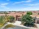 A high angle view of a residential area with uniformly designed homes, palm trees and desert landscaping at 119 E Camellia Way, San Tan Valley, AZ 85140