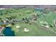 Expansive aerial view shows a golf course with winding fairways, water features, and custom home development at 119 E Camellia Way, San Tan Valley, AZ 85140