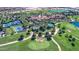 Aerial view showcasing the community pool, tennis court, and green golf course at 119 E Camellia Way, San Tan Valley, AZ 85140