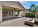 The backyard is landscaped with flowering bushes, a patio, and outdoor fireplace at 119 E Camellia Way, San Tan Valley, AZ 85140