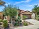 Inviting single-Gathering home boasts lush desert landscaping, adding curb appeal and a welcoming atmosphere at 119 E Camellia Way, San Tan Valley, AZ 85140