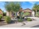 Attractive home featuring a well-maintained yard, desert landscaping, and a brick-accented garage at 119 E Camellia Way, San Tan Valley, AZ 85140
