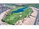 Scenic aerial shot showcases a lush golf course with a water feature surrounded by upscale homes at 119 E Camellia Way, San Tan Valley, AZ 85140