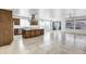 Open-concept kitchen with a large island, stainless steel appliances, and seamless access to the bright living area at 119 E Camellia Way, San Tan Valley, AZ 85140