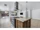 Kitchen island featuring a modern cooktop, range hood, and granite countertop that offers plentiful workspace at 119 E Camellia Way, San Tan Valley, AZ 85140