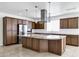 The well-appointed kitchen boasts granite countertops, stainless steel appliances, and an eye-catching modern range hood at 119 E Camellia Way, San Tan Valley, AZ 85140