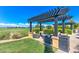 A covered lounge area with comfortable seating offers views of the golf course and surrounding landscape at 119 E Camellia Way, San Tan Valley, AZ 85140