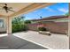 Covered patio featuring a beautiful brick paver floor, fire pit, and view of the landscaped backyard at 119 E Camellia Way, San Tan Valley, AZ 85140