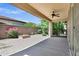 A covered patio features beautiful landscaping and an outdoor fire pit for entertaining at 119 E Camellia Way, San Tan Valley, AZ 85140