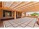 Backyard patio area covered by a trellis, connecting the home's interior and outdoor living spaces at 15073 W Piccadilly Rd, Goodyear, AZ 85395
