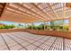 Back patio covered by a trellis, offering a view of the home's landscaped backyard and exterior at 15073 W Piccadilly Rd, Goodyear, AZ 85395