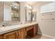 Bathroom featuring double sinks, a vanity area, framed mirrors and a separate shower at 15073 W Piccadilly Rd, Goodyear, AZ 85395